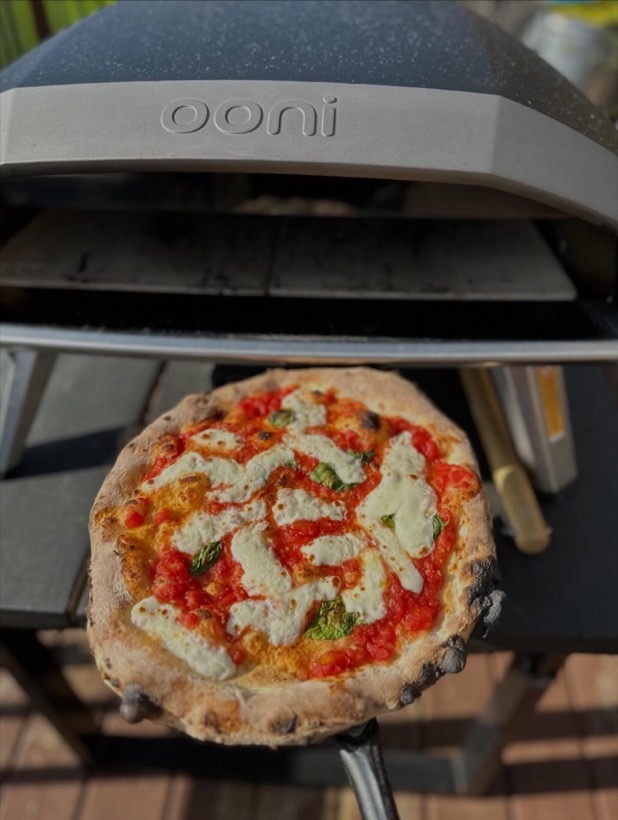 Neapolitan pizza fresh out of the oven with a garlic cream drizzle