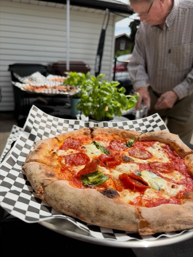Pepperoni and margherita Neapolitan pizza on checkered paper
