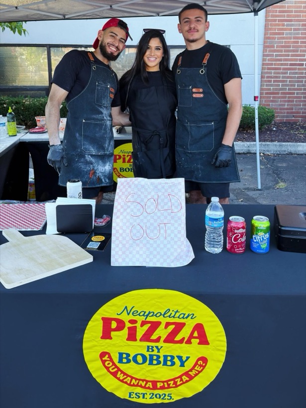 The Pizza by Bobby crew behind the sold-out event table